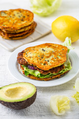 Homemade avocado bun, glutenfree flat bread with patty, lettuce, onion and cream cheese