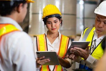 Unity and teamwork. Asian team engineer worker working control sheet metal roof tile roll forming machine at metal sheet profiling factory. Industrial production
