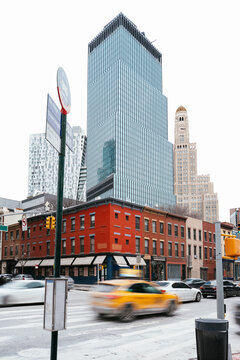 NYC intersection with modern skyscrapers and red-brick buildings