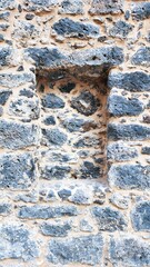 The walls of a very old building made of piles of stones bonded with mud.