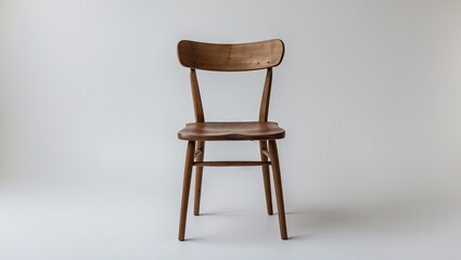 Fototapeta premium Wooden chair with a natural wood finish positioned centrally against a soft white background highlighting its simple, elegant design.