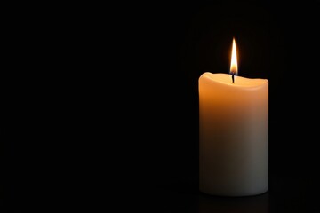 A single burning candle with a soft flame, casting warm light on a dark background. Symbol of hope, remembrance, and tranquility. Ai generative