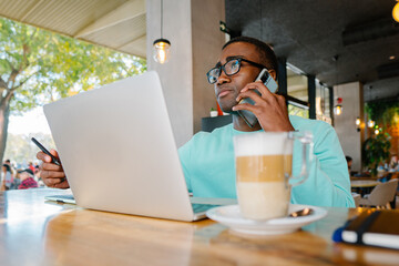 Professional multitasking in a modern coffee shop setting