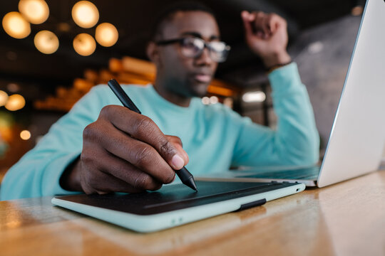 Creative professional using tablet and laptop in modern workspace