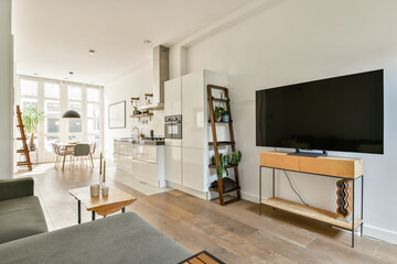 A stylish modern living space featuring a cozy seating area, large windows for natural light, and contemporary furniture design. Ideal for relaxation and socializing.
