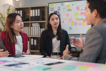 Business team discussing project strategy during meeting in office