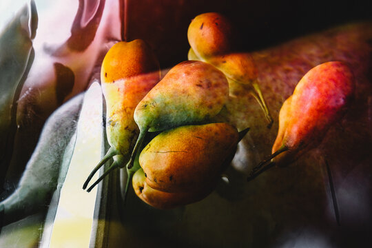 Fresh pears resting on a wooden table in warm sunlight - Powered by Adobe