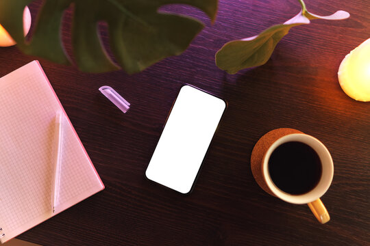 Workplace with modern smartphone, notepad and cup of tea. Flat lay