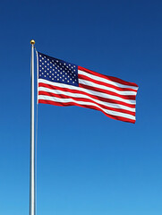 Fototapeta premium Flag waving proudly in clear blue sky