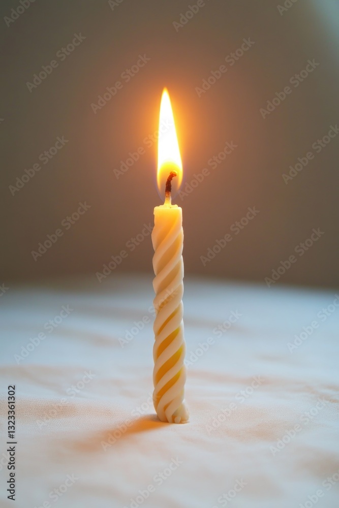Poster A simple lit candle placed on a table with no other objects or distractions