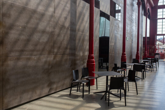 black chairs and tables against black wall