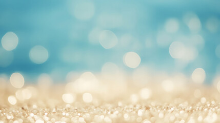 Fototapeta premium Golden sandy beach with soft blur bokeh blue sea and sky background, perfect for summer vacation and travel concepts.