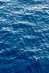 Sea surface. Blue water texture. Close up blue water surface at deep ocean