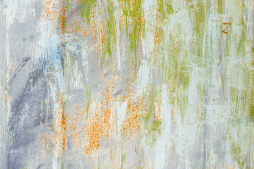 Old weathered wall with multi-colored peeling paint, background texture