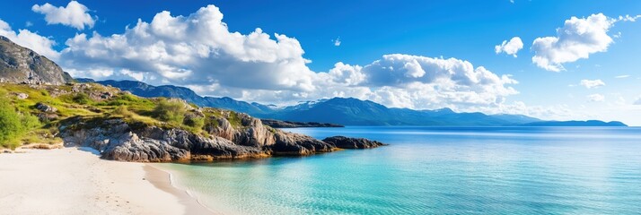 Obraz premium Scenic shoreline with clear waters and mountains under a bright sky in a coastal paradise