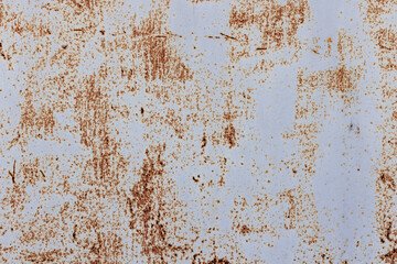Texture of a gray weathered metal surface displaying rusty brown spots