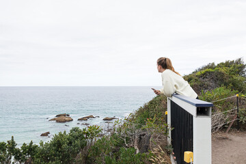 A woman in a lookout see an Australian beach of Merimbula