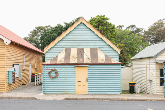 Charming Blue House with Rustic Roof on Street in Tilba Australia