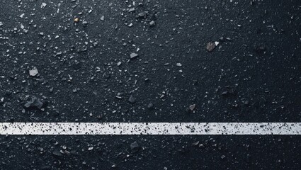 Asphalt texture background with white dashed line centered horizontally on dark gray surface featuring scattered stones creating ample copy space.
