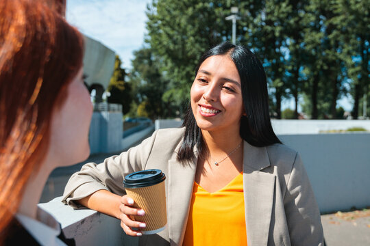 Businesswomen chatting in a coffee break outdoors