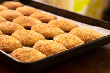Cottage cheese pancakes on a baking sheet.Dessert.Syrniki