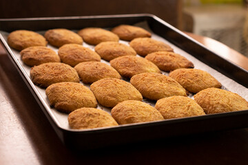 Cottage cheese pancakes on a baking sheet.Dessert.Syrniki