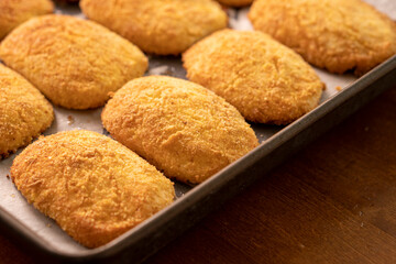 Cottage cheese pancakes on a baking sheet.Dessert.Syrniki