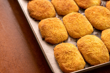 Cottage cheese pancakes on a baking sheet.Dessert.Syrniki