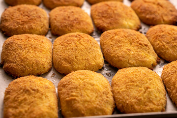 Cottage cheese pancakes on a baking sheet.Dessert.Syrniki