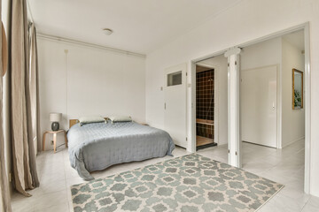 A stylish, modern bedroom featuring minimalist decor, neutral colors, and a cozy ambiance. Perfectly arranged furniture enhances its inviting look.
