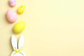 Happy Easter. Colorful eggs with bunny ears on color background, space for text or advertising