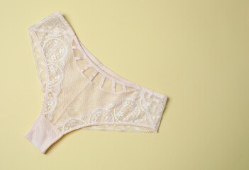Flat lay with women romantic underwear on beige background, top view