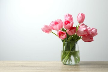 Beautiful fresh tulips in a vase on the table