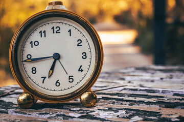 Vintage Clock on a Rustic Wooden Table Outdoors