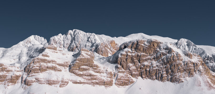 Panorama of winter mountain range and blue sky