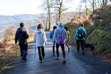 Group of hikers walking on a mountain road in Spain