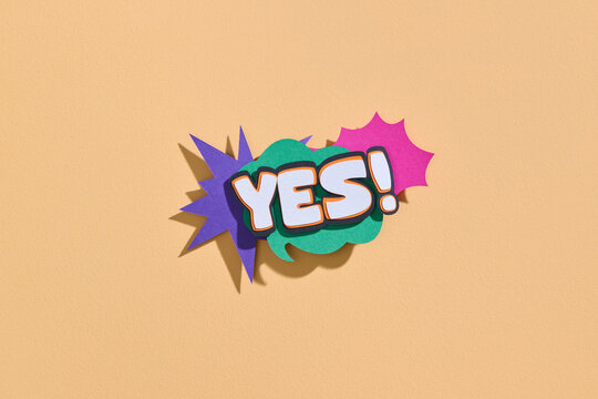 Colorful Comic Style 'Yes!' Text on Beige Background
