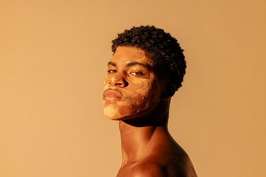 close up of man using clay on face for skin care