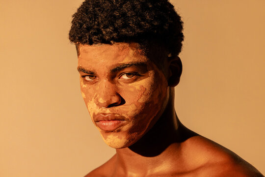 close up of man using clay on face for skin care
