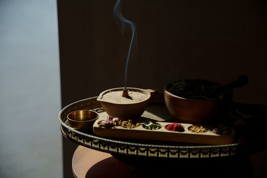 Incense Ritual with Herbs and Bowls in Golden Light
