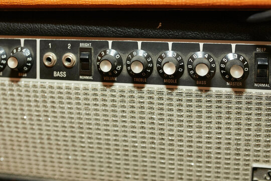 Close-up of a vintage guitar amplifier with detailed control knobs and inputs.