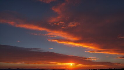 Naklejka premium Vibrant orange sunset with dark silhouettes in the foreground against a deep blue sky, featuring ample copyspace for text or design elements.