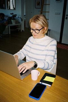 Blonde woman works from her apartment