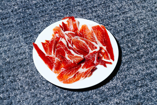 plate with some spanish serrano ham on the floor