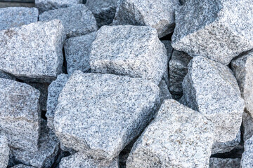 Pile of grey granite cobblestones for paving