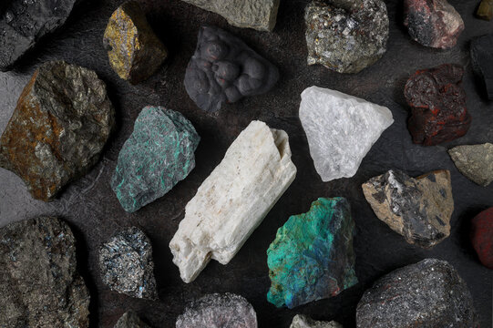 Mixture of critical minerals (United States of America definition), or critical raw materials (European Union definition). Flatlay on slate background