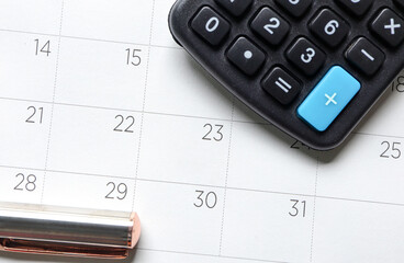 Close up of paper desk calendar for date 31 and pen, calculator on white clean calendar. Concept Last days of month, payday