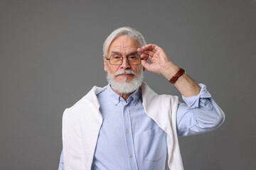Fototapeta premium Portrait of stylish bearded man on grey background