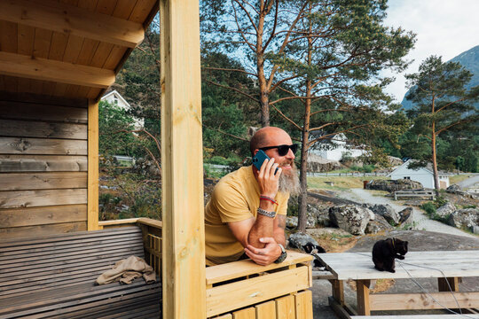 Man talking on the phone on his porch