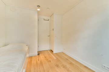 A minimalist interior space showcasing a clean design with wooden flooring and subtle lighting, emphasizing simplicity and elegance.